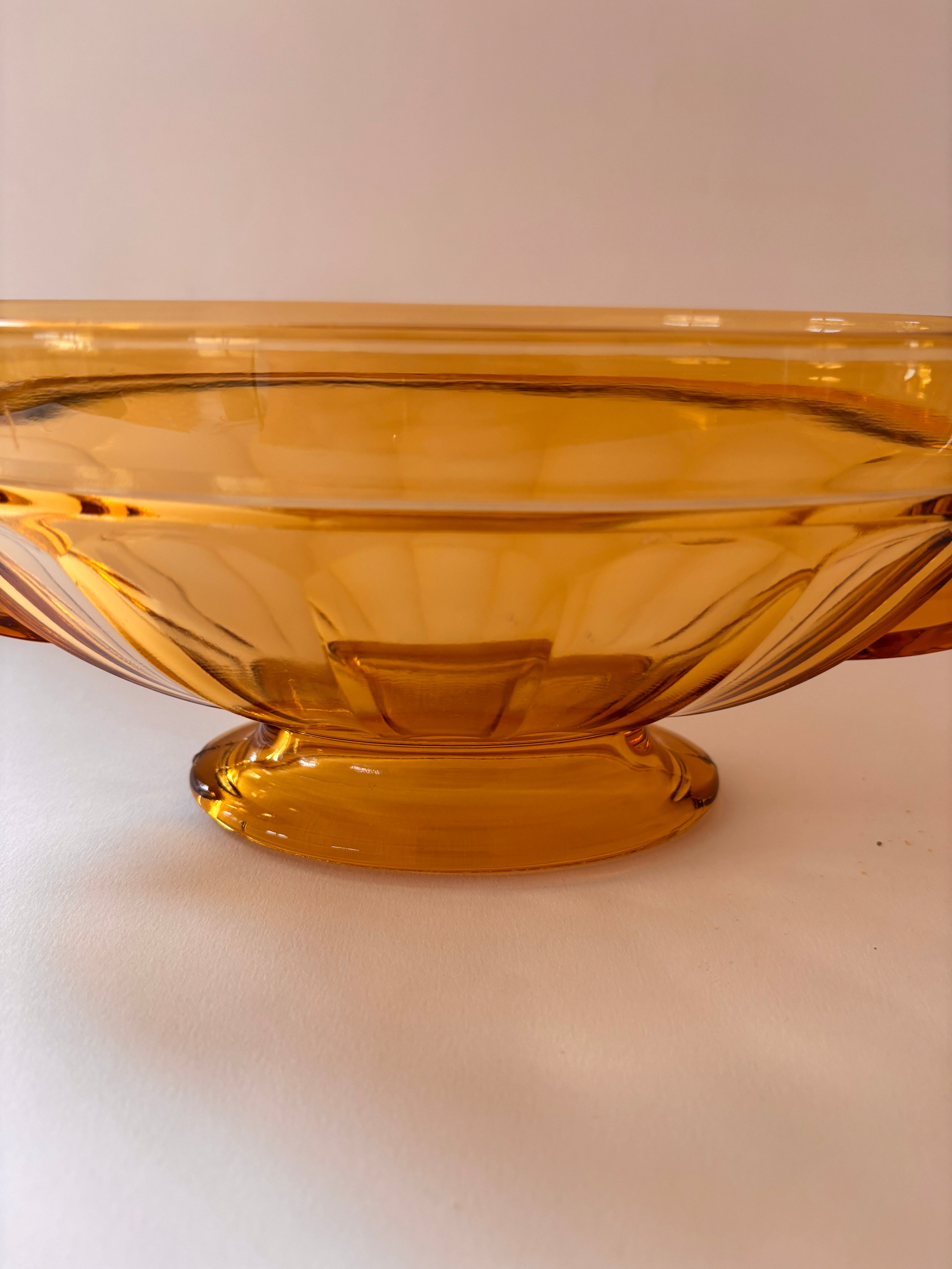 Close up of vintage Val Saint Lambert bowl showing oval form and amber glass depth.