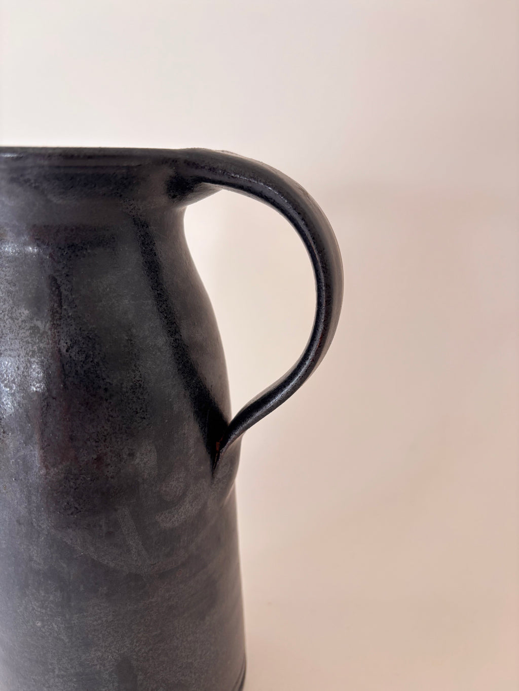 black glaze vintage stoneware jug showing handle 
