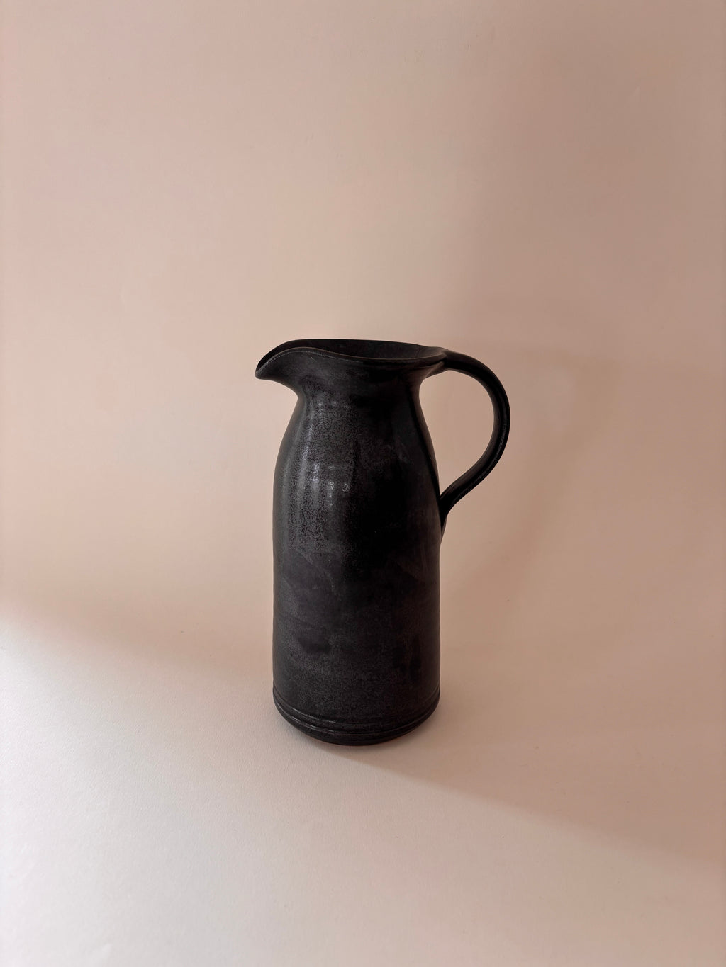 Black glaze vintage stoneware jug with loop handle