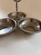 Close-up of beaded edge detail on a vintage Jean Couzon stainless steel serving bowl