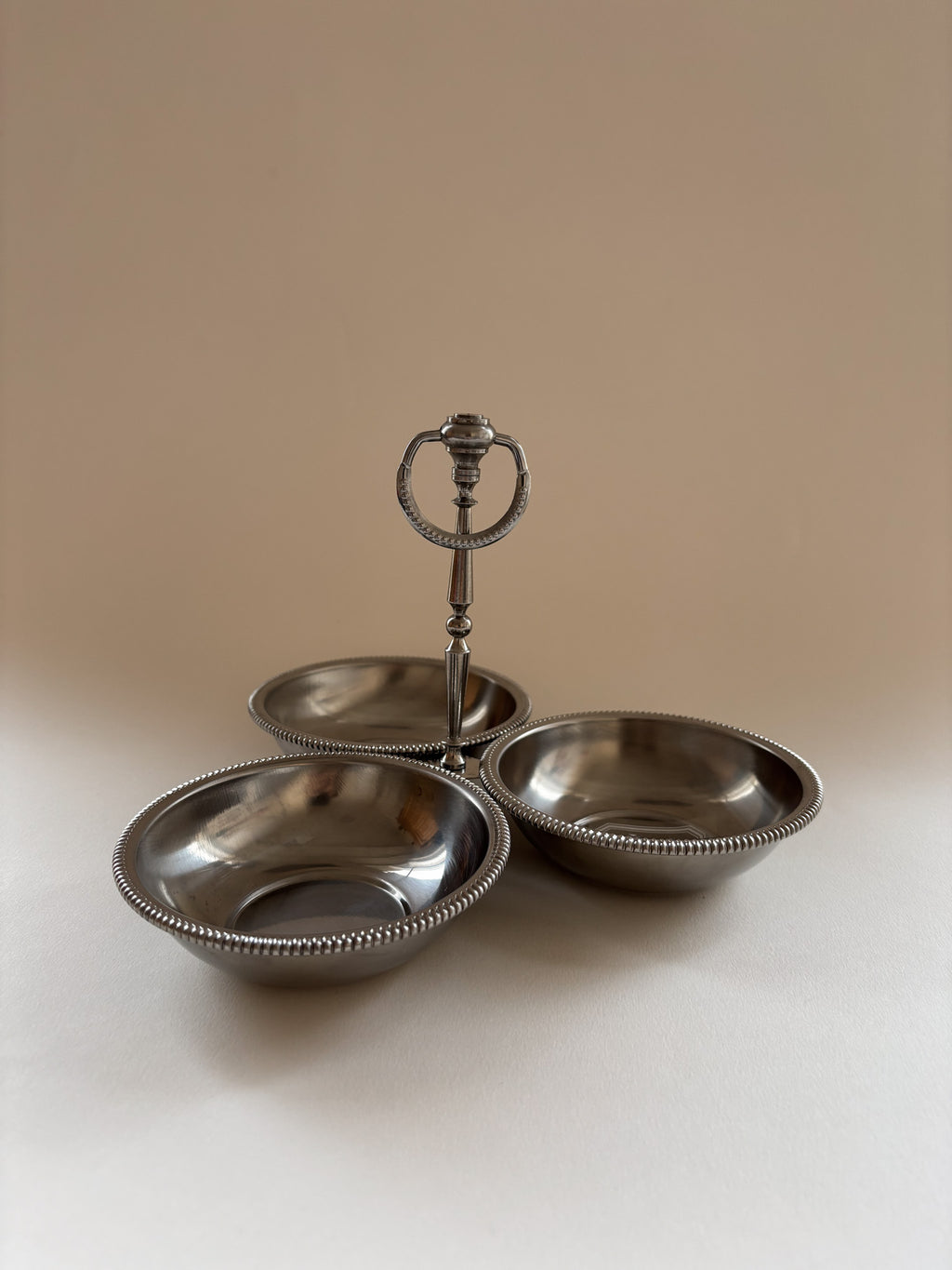 vintage Jean Couzon stainless steel server showing central handle height and bowl depth