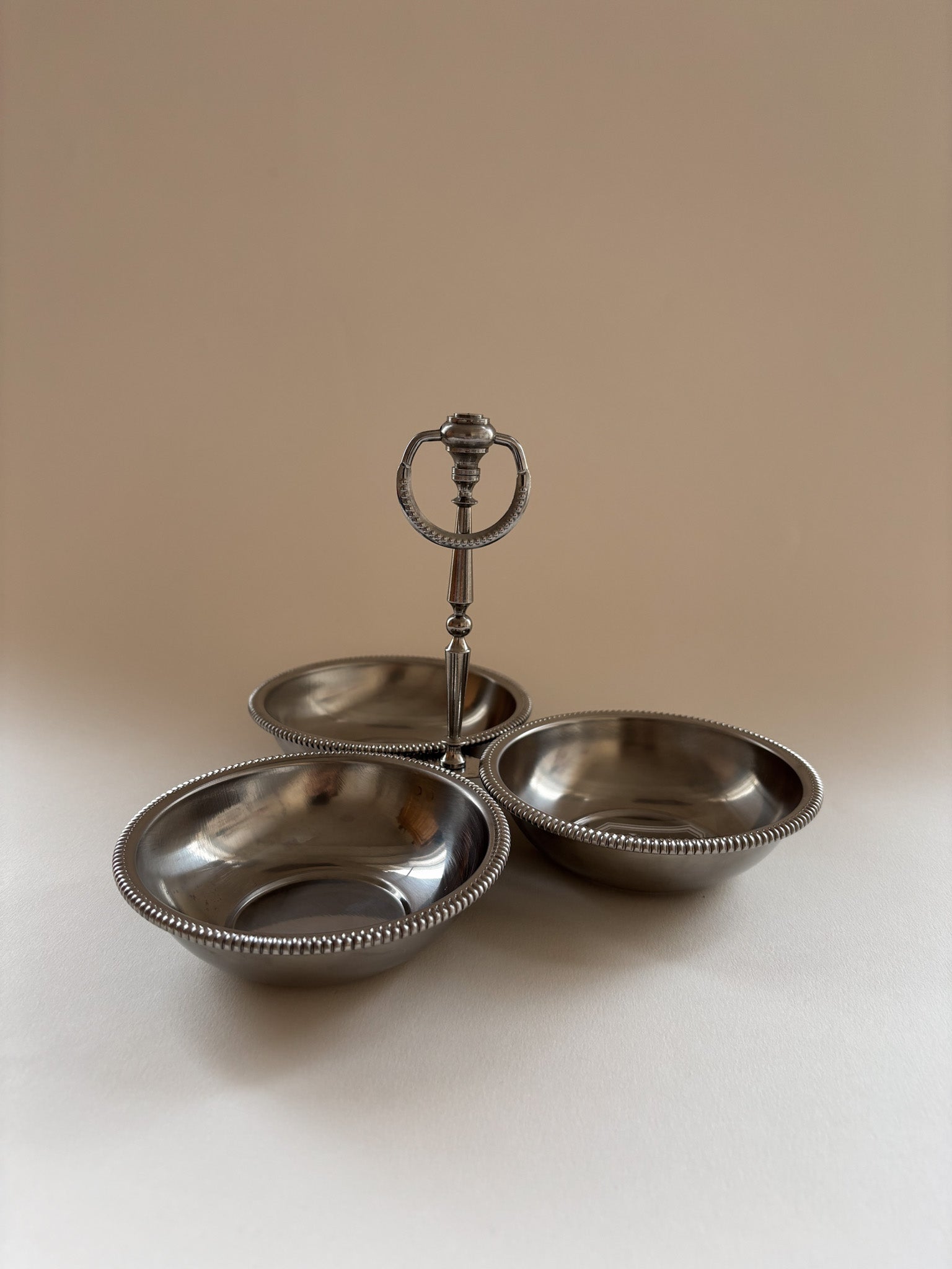 vintage Jean Couzon stainless steel server showing central handle height and bowl depth