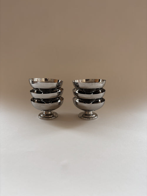 Set of six vintage stainless steel dessert cups by L'Étang & Rémy stacked together.