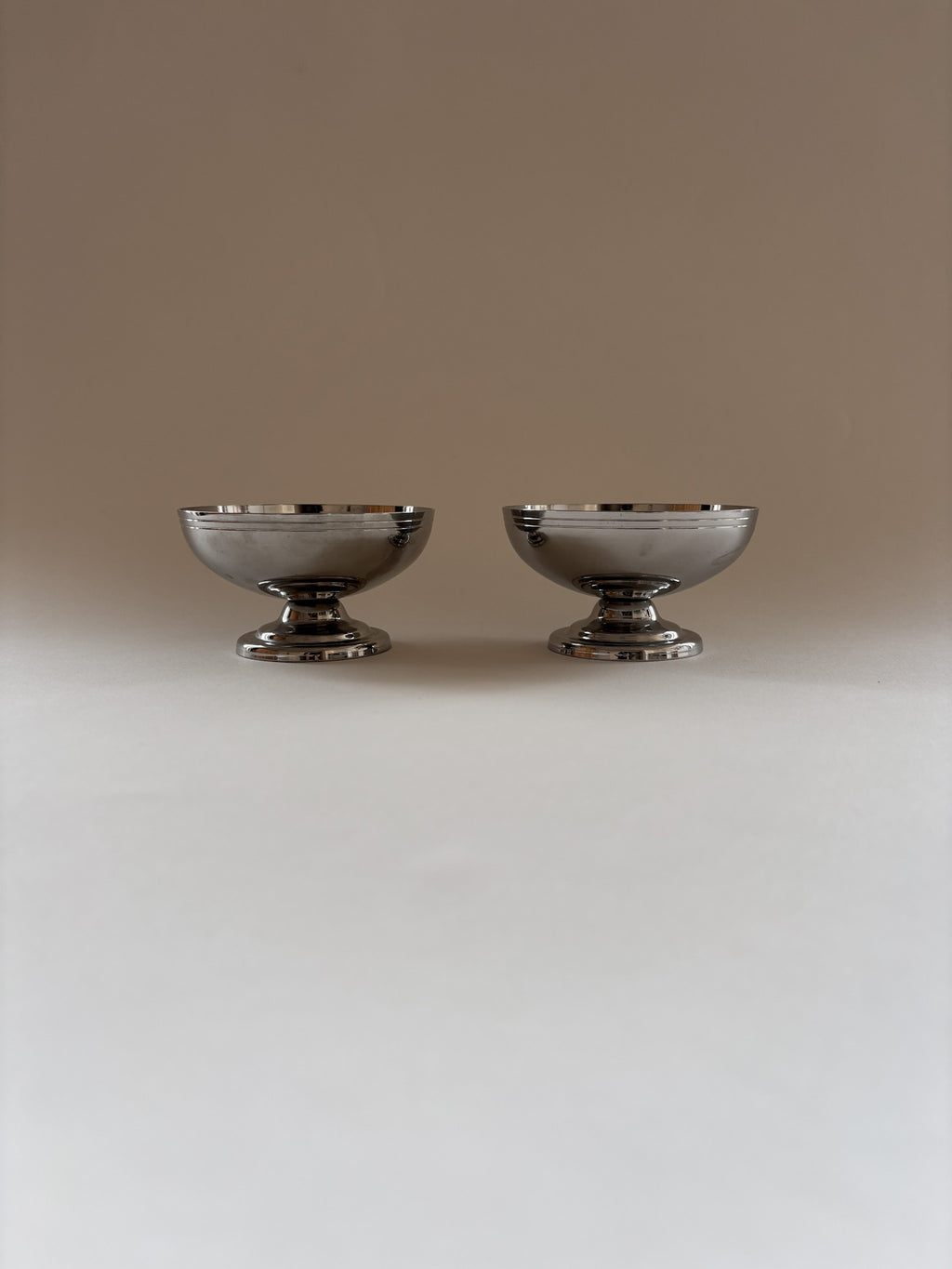 Two vintage L'Étang & Rémy stainless steel dessert cups  showing depth and form