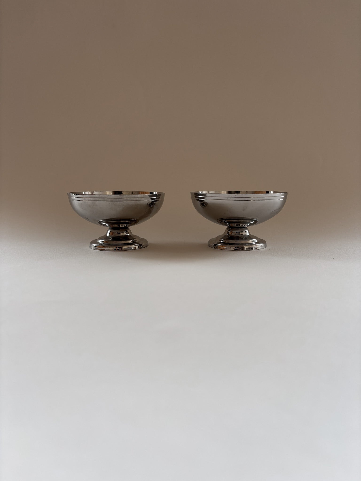 Two vintage L'Étang & Rémy stainless steel dessert cups  showing depth and form