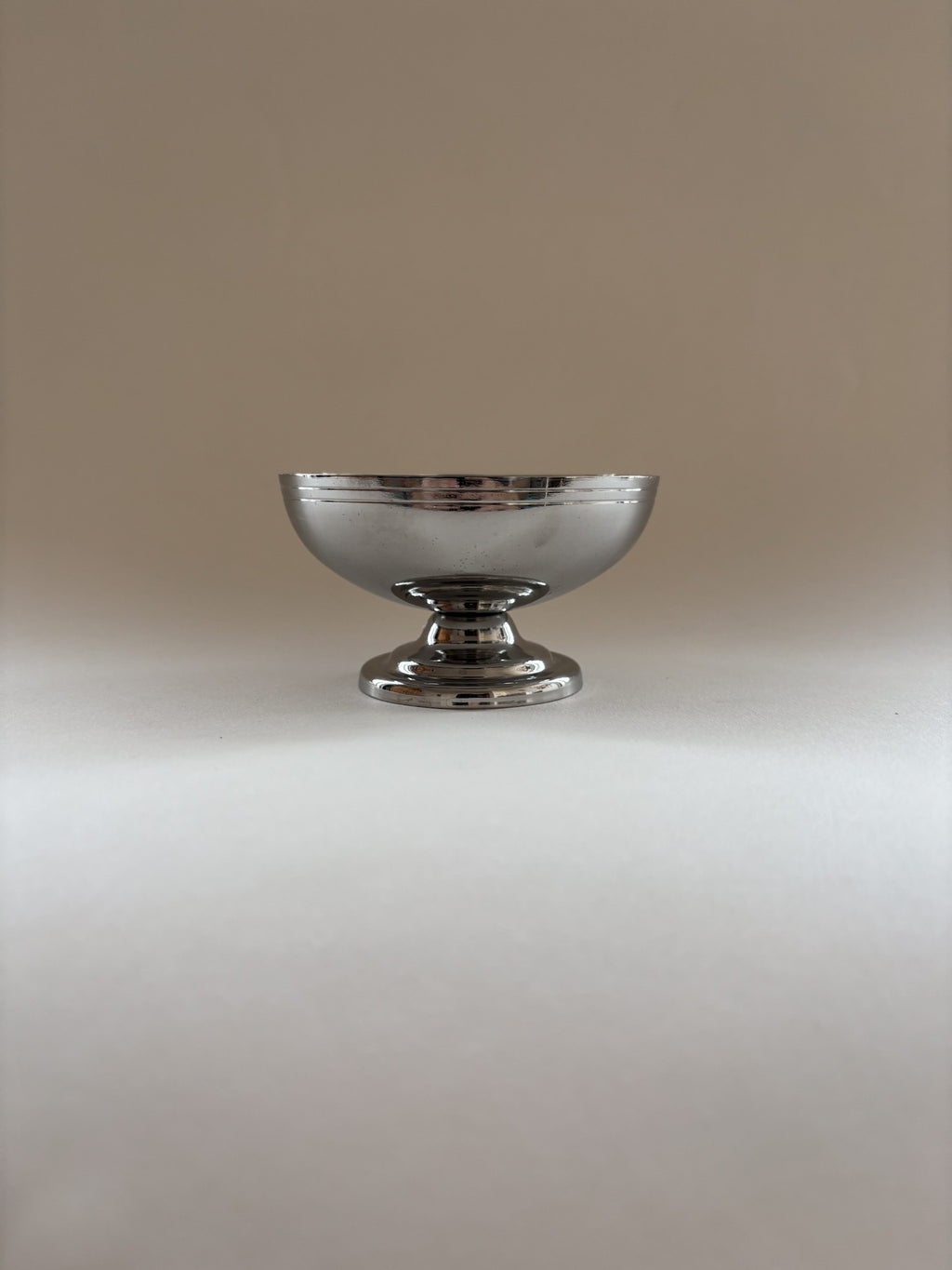 Single vintage stainless steel dessert cup by L'Étang & Rémy showing minimalist curves