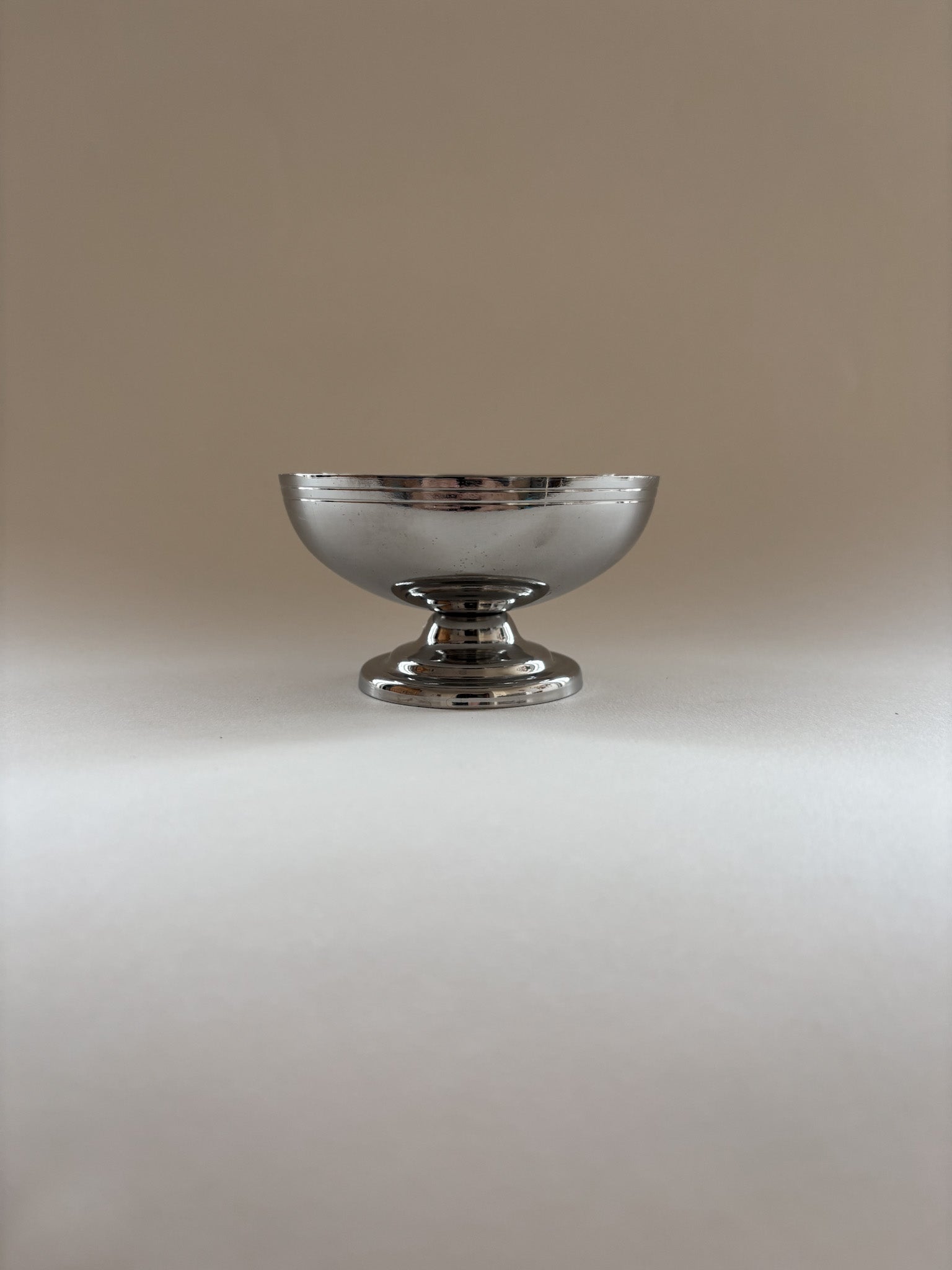 Single vintage stainless steel dessert cup by L'Étang & Rémy showing minimalist curves