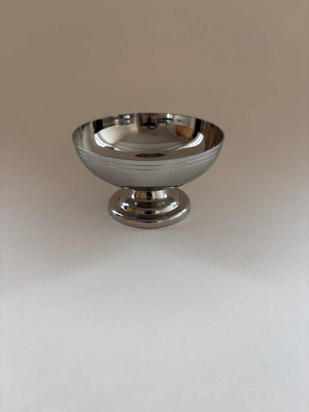 Single vintage stainless steel dessert cup by L'Étang & Rémy showing minimalist curves and brushed finish