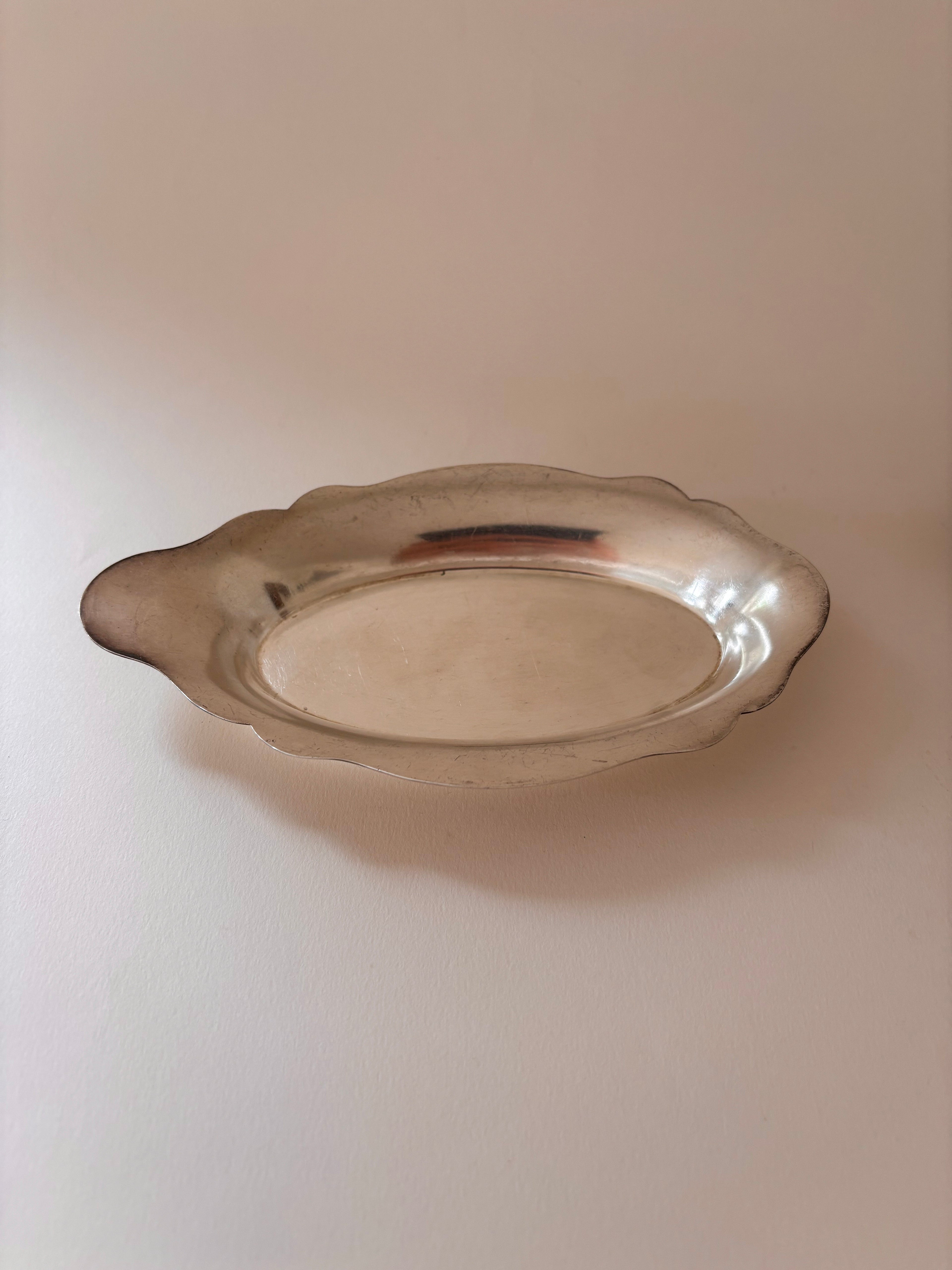Front view of a vintage silver-plated oval dish