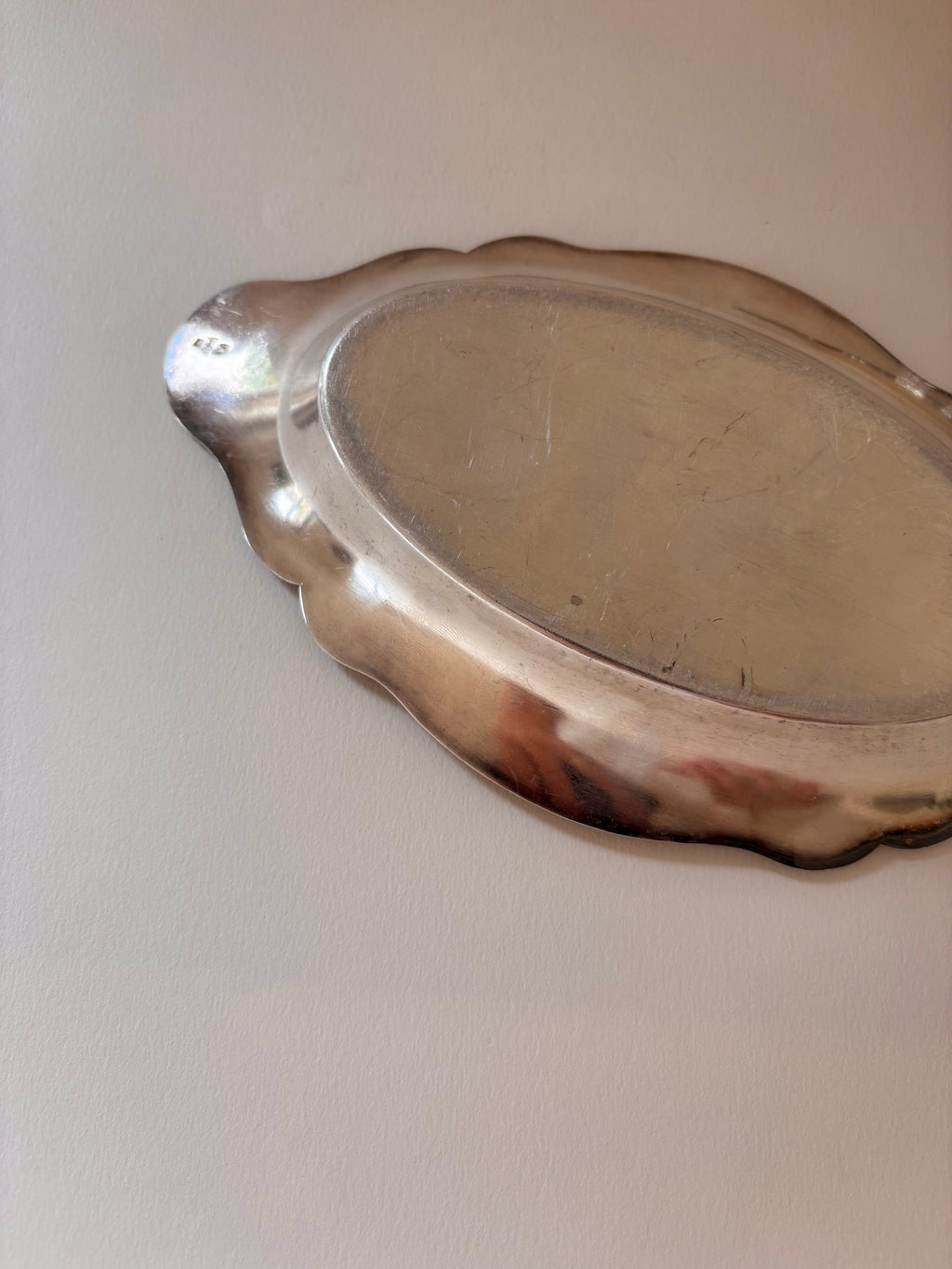 Back view of a vintage silver-plated oval dish showing base and underside detail.