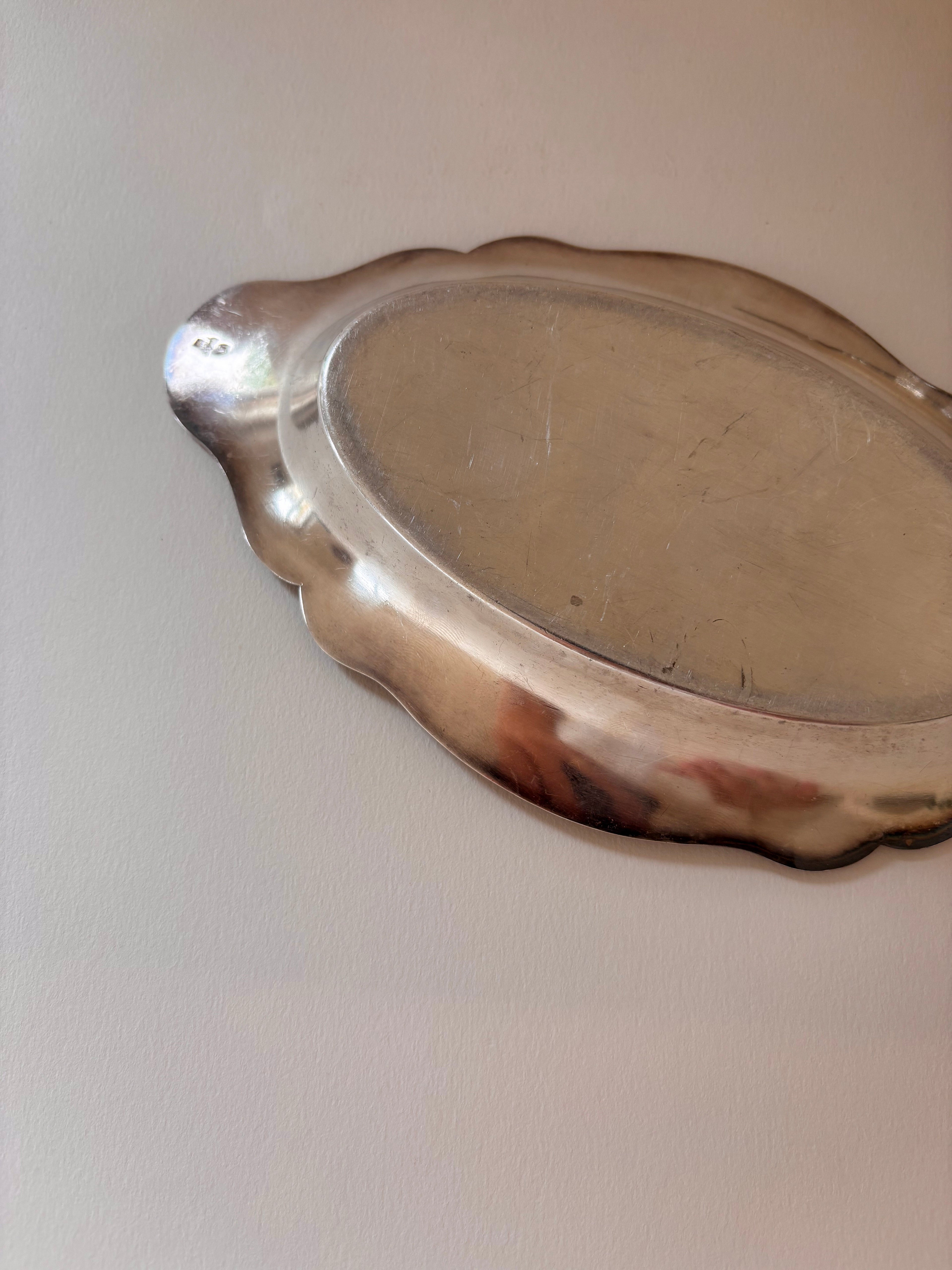 Back view of a vintage silver-plated oval dish showing base and underside detail.