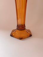 Close-up of hexagonal base of a vintage Val Saint Lambert amber pressed glass vase