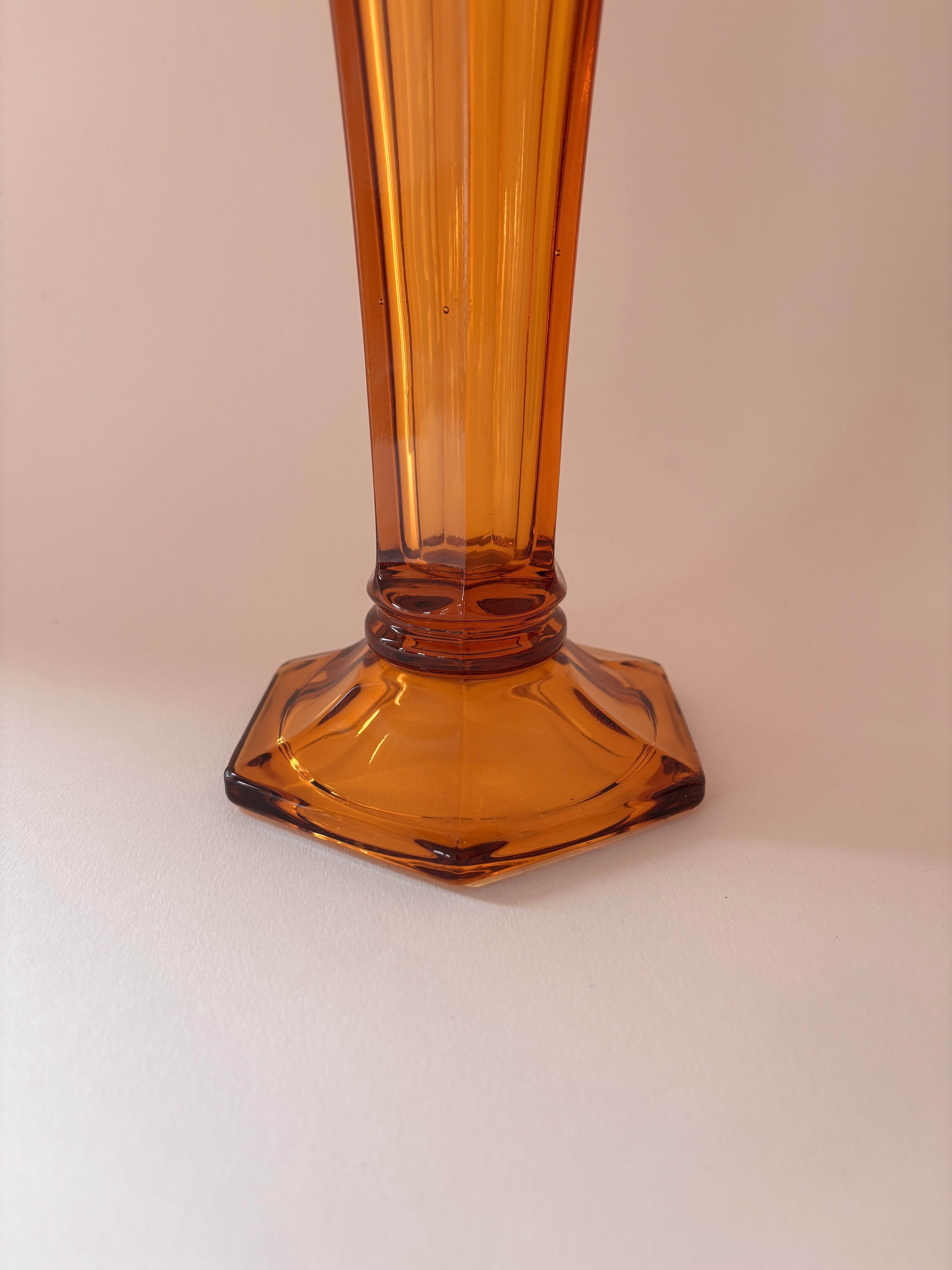 Close-up of hexagonal base of a vintage Val Saint Lambert amber pressed glass vase