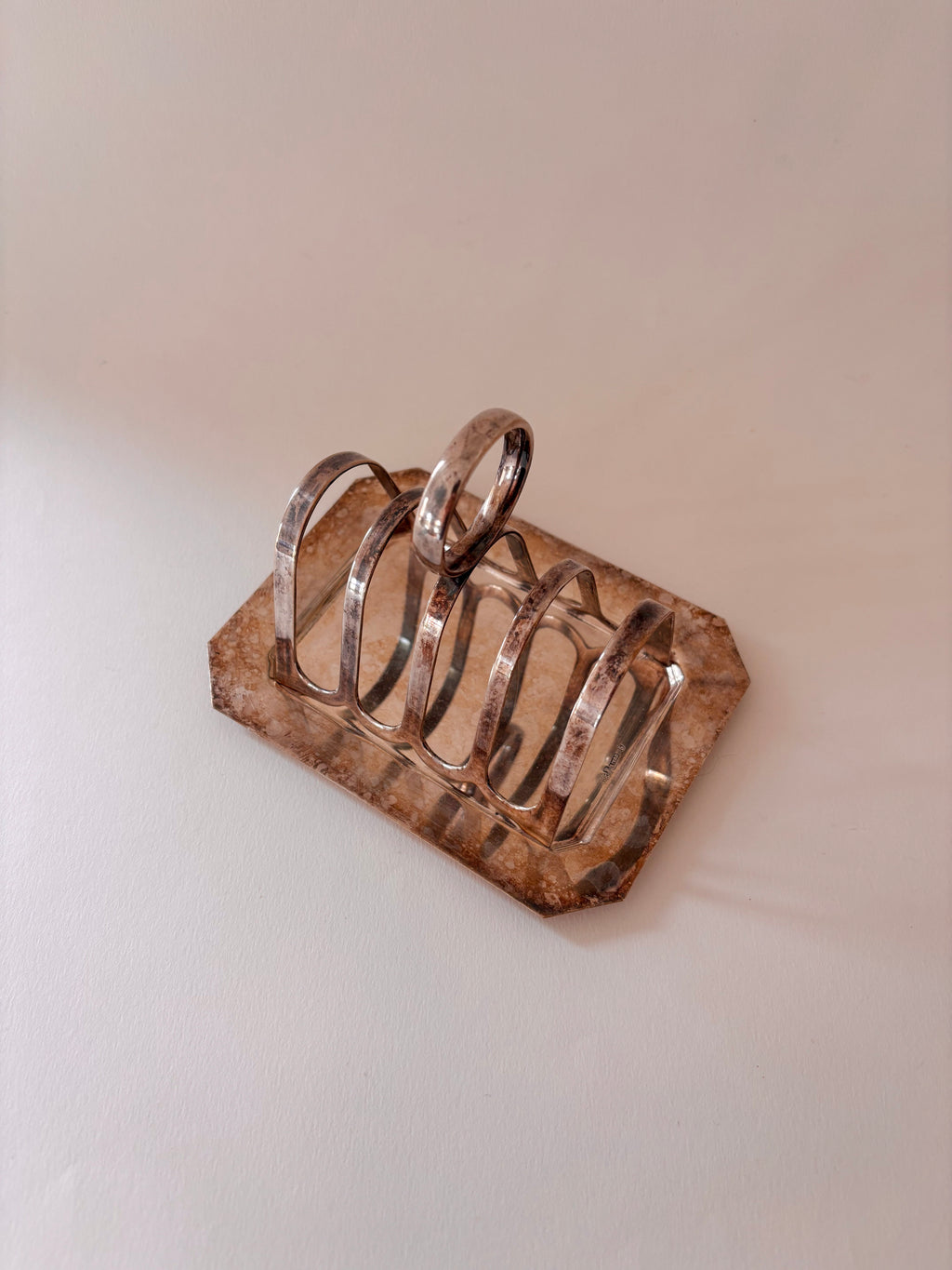 vintage silver-plated toast rack and its removable crumb tray 