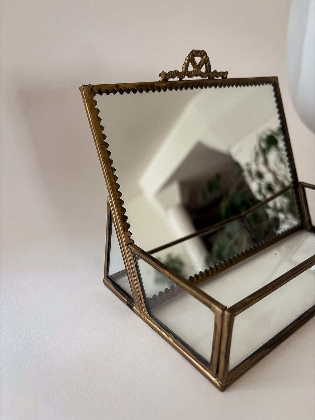 Side view of vintage brass and glass vanity box