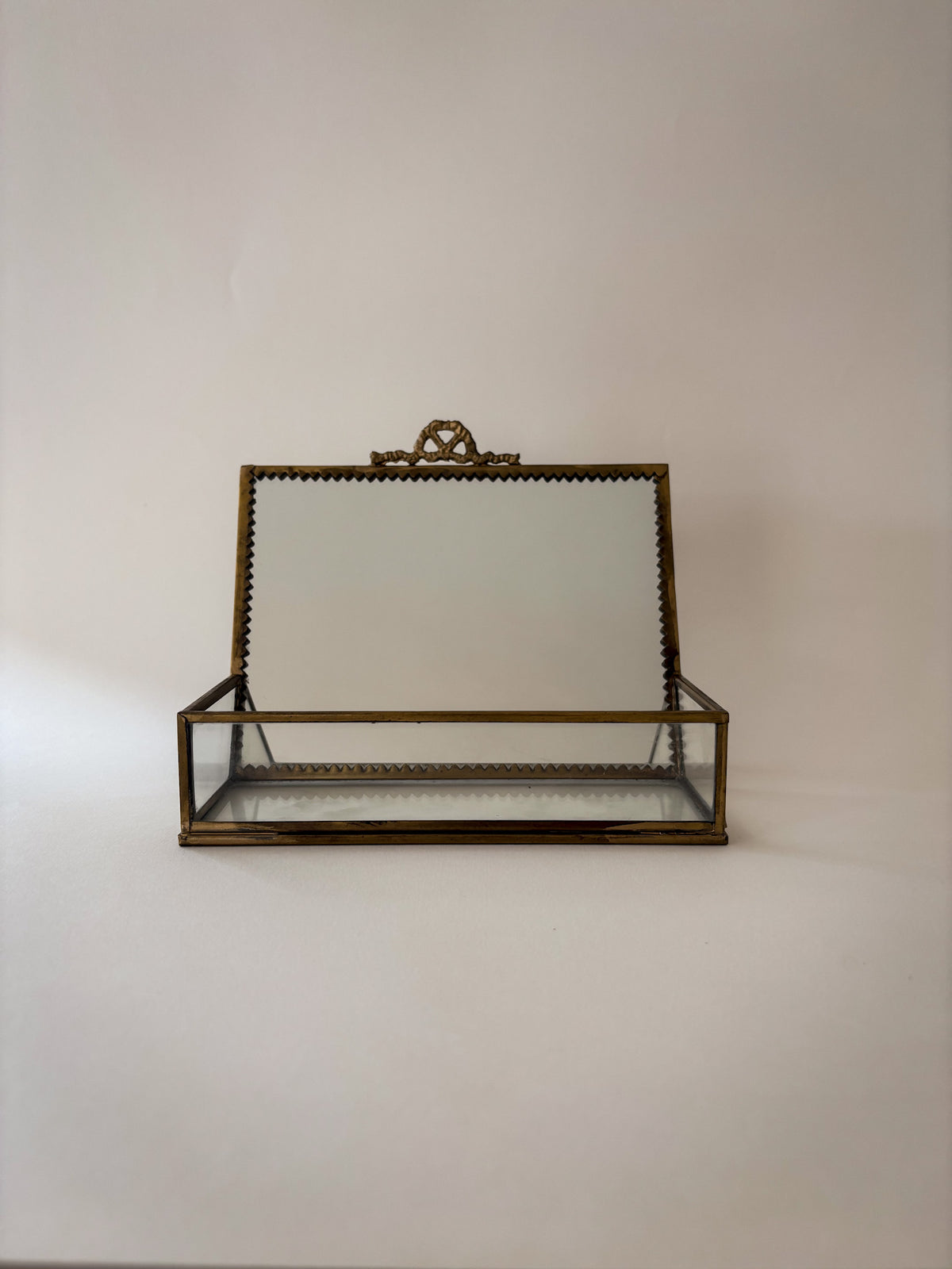Mirrored upper panel of vintage brass and glass vanity box