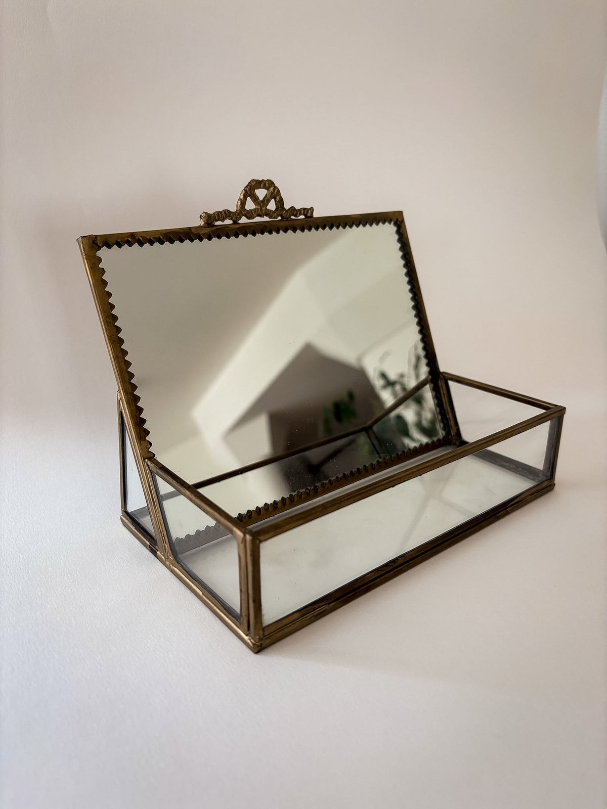Vintage brass and glass vanity box with a mirror